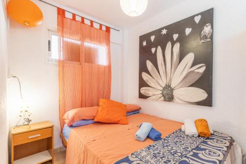 a bedroom with a bed and a painting on the wall at Moby Dick in Benidorm