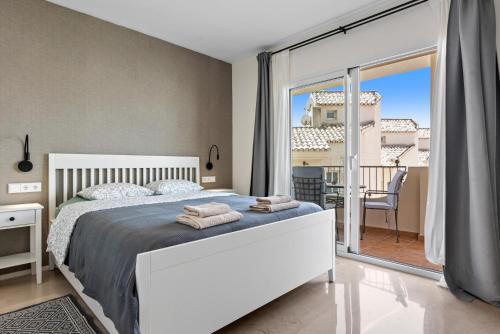 a bedroom with a large bed and a balcony at Casa Sunshine in Marbella