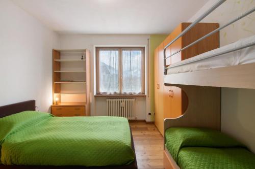 a bedroom with two bunk beds and a window at Como Lake Home in Colico