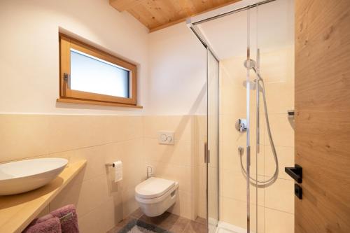 a bathroom with a shower and a toilet and a sink at Ferienwohnung 2 Weger in Andrian