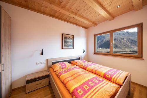 two beds in a bedroom with a window at Ferienwohnung 2 Weger in Andrian