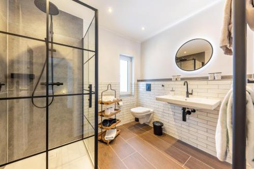 a bathroom with a shower and a sink and a toilet at Ferienwohnung Jost in Sundern