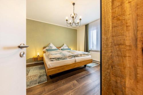 a bedroom with a bed and a sliding door at Ferienwohnung Jost in Sundern