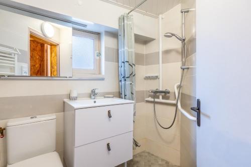 a bathroom with a toilet sink and a shower at Maison traditionnelle au centre in Les Sables-d'Olonne