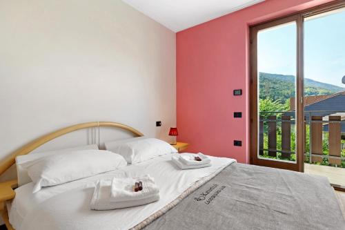 a bedroom with a bed and a large window at Katzemburg 5 Plus in Arco