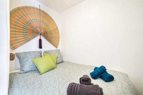 a bedroom with a bed with a umbrella on it at Mon Repaire à Frejus - proche plage in Fréjus