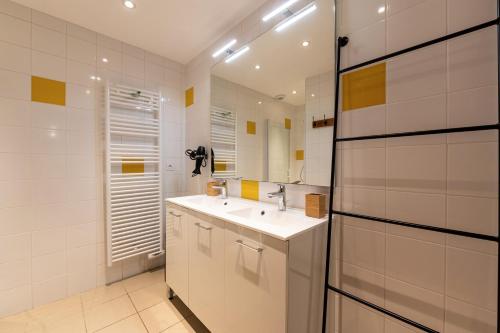 a bathroom with a sink and a mirror at Chalet Arclosan - Val de Tamié in Faverges