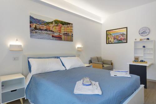 a bedroom with a blue bed and a chair at Portofino Garden in Rapallo