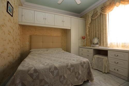 a bedroom with a bed and a sink and a window at Romantic Villa with private Pool in Adeje