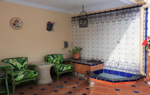 a living room with two chairs and a window at Romantic Villa with private Pool in Adeje