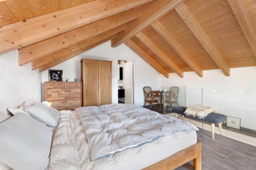 a bedroom with a large bed and a table at Charmingly Renovated Stone House in Cesara