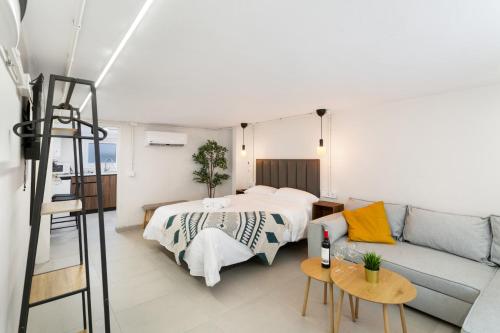 a living room with a bed and a couch at Atw Studio in Guanarteme