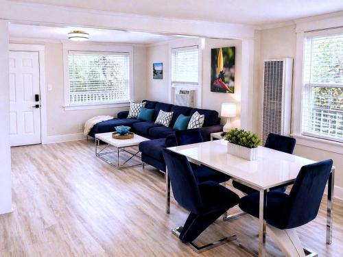 a living room with a blue couch and a table at CasaViva Breeze - 2BR with Sunset Views, Firepit & Backyard - Walk to Fun & Eats in North Park & Hillcrest, 5 Min to Gaslamp in San Diego