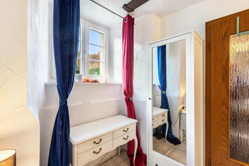 a bathroom with a vanity and a window and a mirror at Appartment Schlossmühle in Olsberg in Olsberg