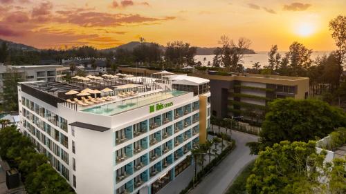 an aerial view of a building with the sunset in the background at ibis Styles Phuket Bangtao in Bang Tao Beach