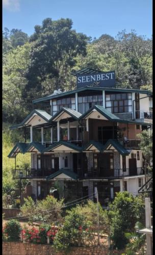 a hotel on the side of a hill with umbrellas at SEENBEST Ella in Ella