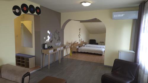 a living room with a bed and a mirror at Guest Rooms Flirt in Golden Sands