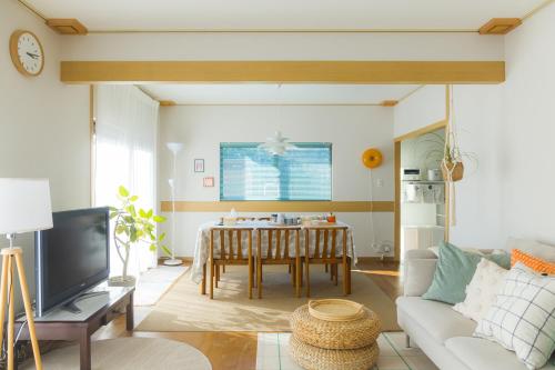a living room with a couch and a table at kaze no ne in Takachiho
