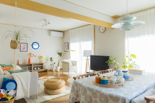 a living room with a table and a couch at kaze no ne in Takachiho