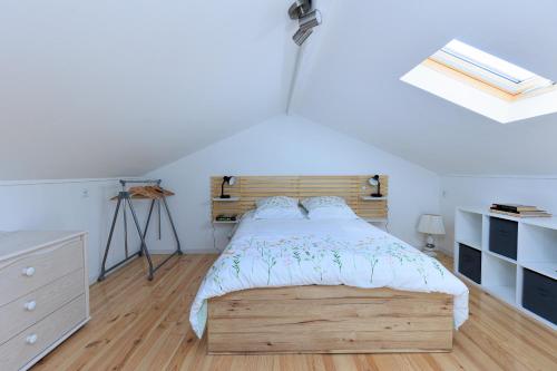 a bedroom with a bed with a wooden headboard at Loc Ty Home in Soustons