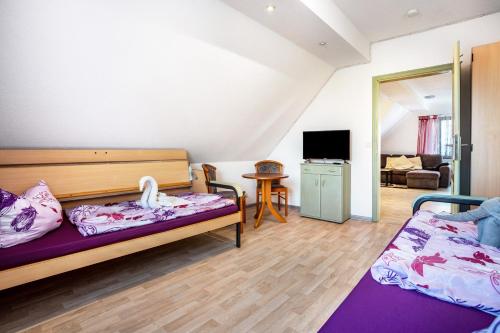 a room with two beds and a living room at Ferienwohnung über 2 Etagen in Trollenhagen