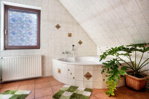 a bathroom with a tub and a window at Ferienwohnung über 2 Etagen in Trollenhagen