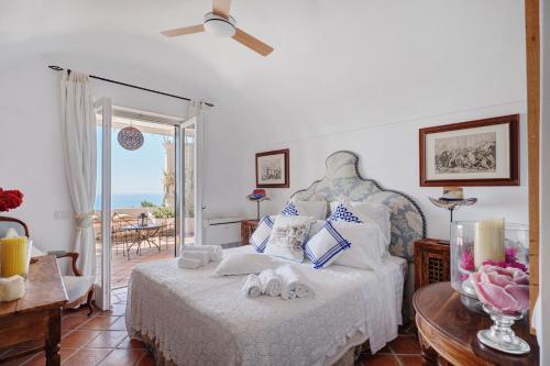 a bedroom with a bed and a view of the ocean at Villa Bella Vista in Capri