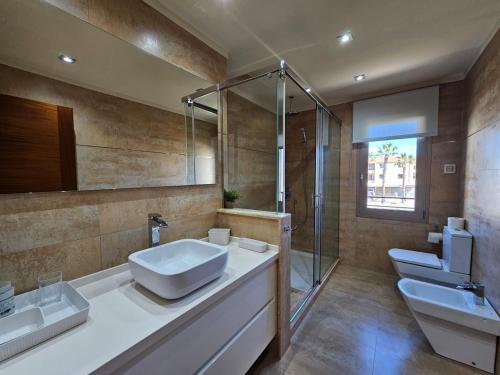 a bathroom with two sinks and a shower at Antonia in Can Picafort
