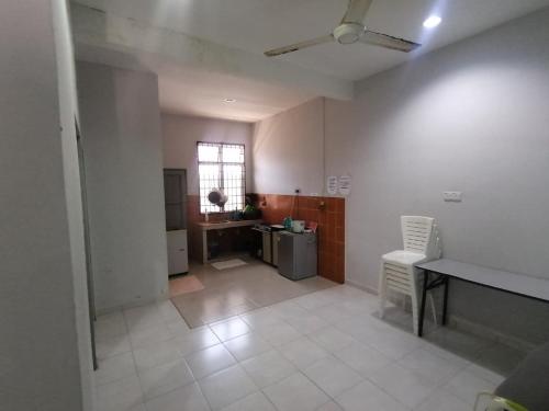 a living room with a table and a window at Promenade Homestay 2 in Kampong Sura Masjid