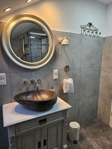 a bathroom with a sink and a mirror at Ferienwohnung Solling-Lounge in Holzminden