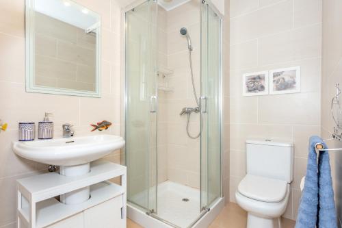 a bathroom with a shower and a sink and a toilet at Vista Faváritx in Es Mercadal