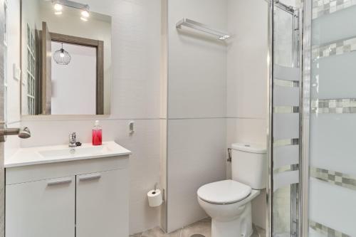 a bathroom with a toilet and a sink and a shower at Nerja Boutique 103 Sweet Corner in Nerja