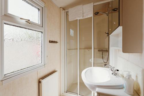 a bathroom with a sink and a shower at Villa Hexengericht in Thale