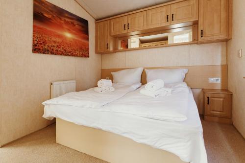 a bedroom with a large bed with white sheets at Villa Hexengericht in Thale