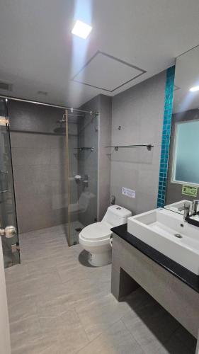 a bathroom with a toilet and a shower and a sink at joyful the Kris406 in Ban Lum Fuang