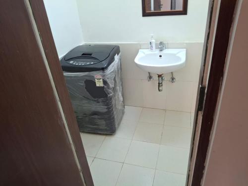 a bathroom with a trash bag and a sink at Express view homes in Noida