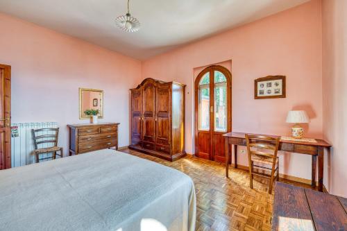 a bedroom with a bed and a desk and chairs at Villa Marta in Spoleto