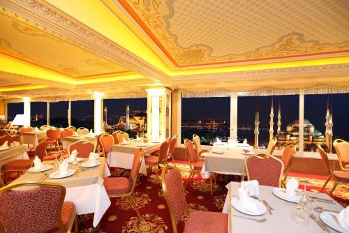 a restaurant with tables and chairs and a view of the city at Deluxe Golden Horn Sultanahmet Hotel in Istanbul