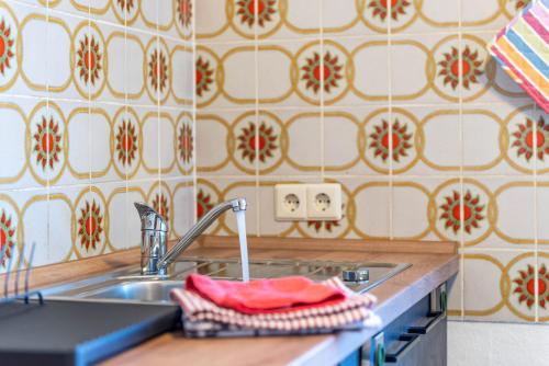 a kitchen sink with a red towel on it at Fribo in Ostrach