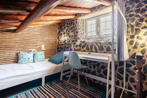 a bedroom with a bunk bed and a desk at Casa Do Castelo in Beja