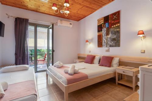 a bedroom with a bed and a balcony at Nontas Homes 37 in Kalamitsi
