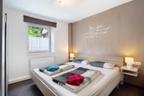 a bedroom with a large bed with two pillows on it at Fewo In Schustes in Willingen