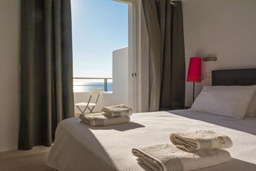 a bedroom with a bed with towels on it at Kaladi Rock Avlemonas in Avlemonas