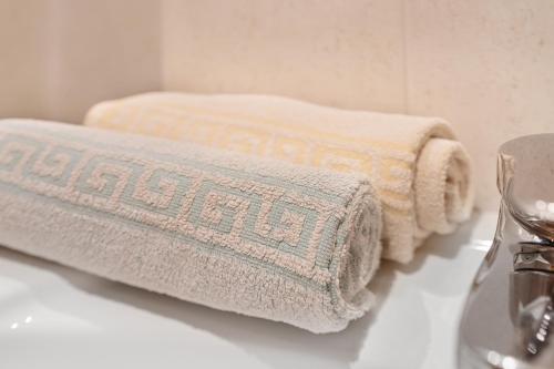 two towels are sitting on a counter in a bathroom at Appartement Egart 1 in Resia