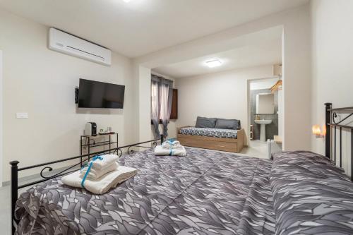a bedroom with a large bed with towels on it at Villa Giovia in Guspini