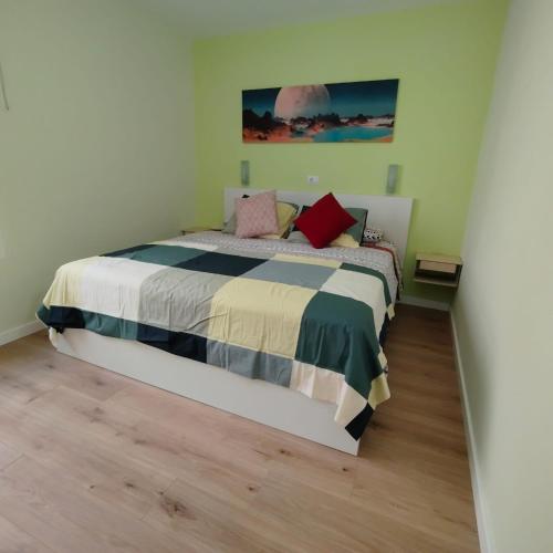 a bedroom with a bed and a painting on the wall at Apartamento Joya in Puerto Rico de Gran Canaria