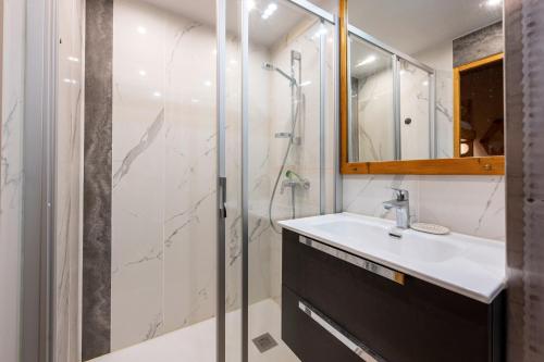 a bathroom with a sink and a shower at Appartement 26 - 9 personnes in Les Allues