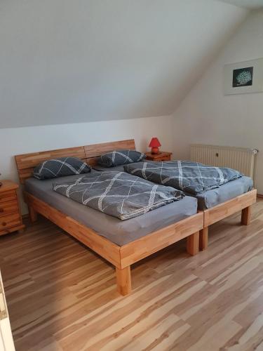 a bedroom with a large wooden bed with blue pillows at Ferienwohnung in Etelsen in Langwedel
