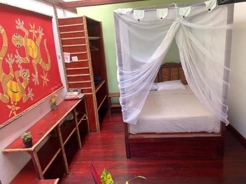 a bedroom with a canopy bed and bunk beds at Villa 3 - High End Studio Apartment with kitchen, Playa Chiquita in Cocles