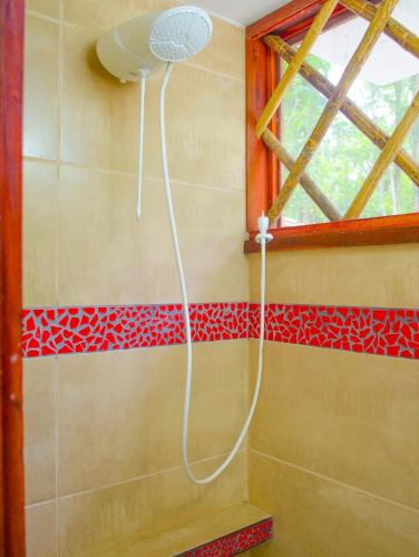 a shower in a bathroom with red tiles at Villa 3 - High End Studio Apartment with kitchen, Playa Chiquita in Cocles